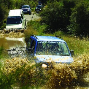 Off Road Suzuki Jimnys driving through mud puddles